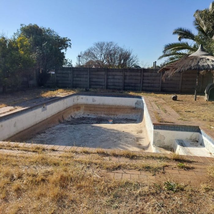 Image of of the empty and broken swimming pool at the C.H.A.N.C.E. Children's Home
